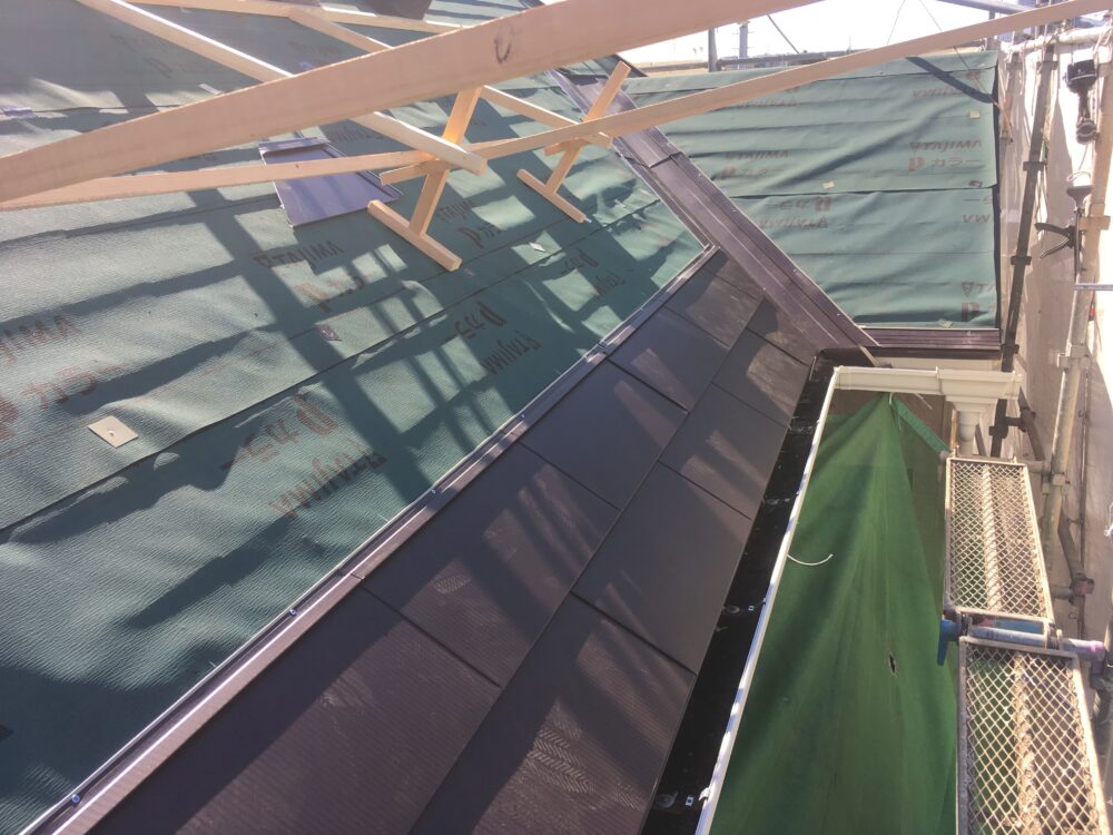 軒先側から葺き上げ中(防水層→本体の順で進行)